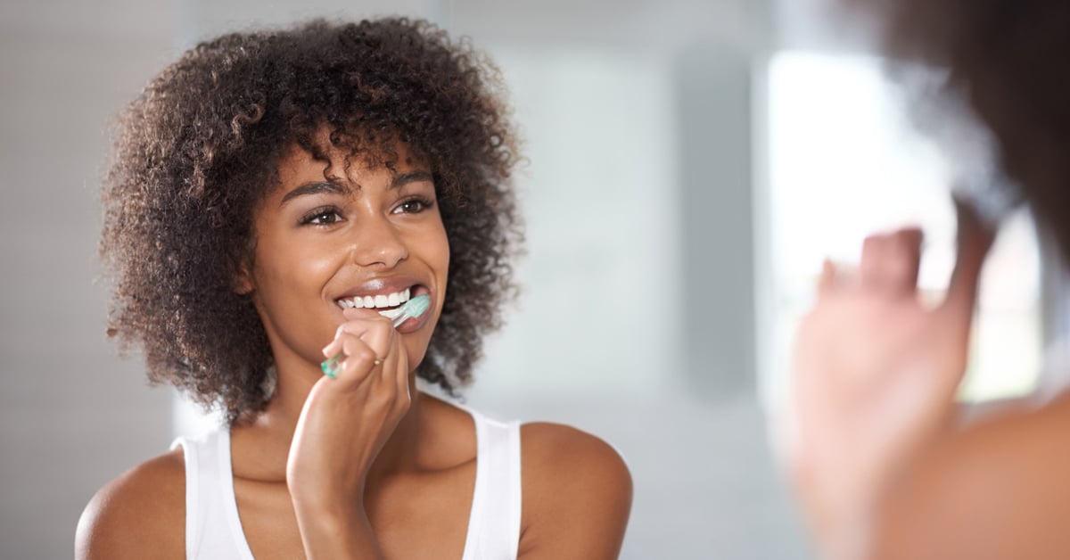 Woman brushing her teeth.