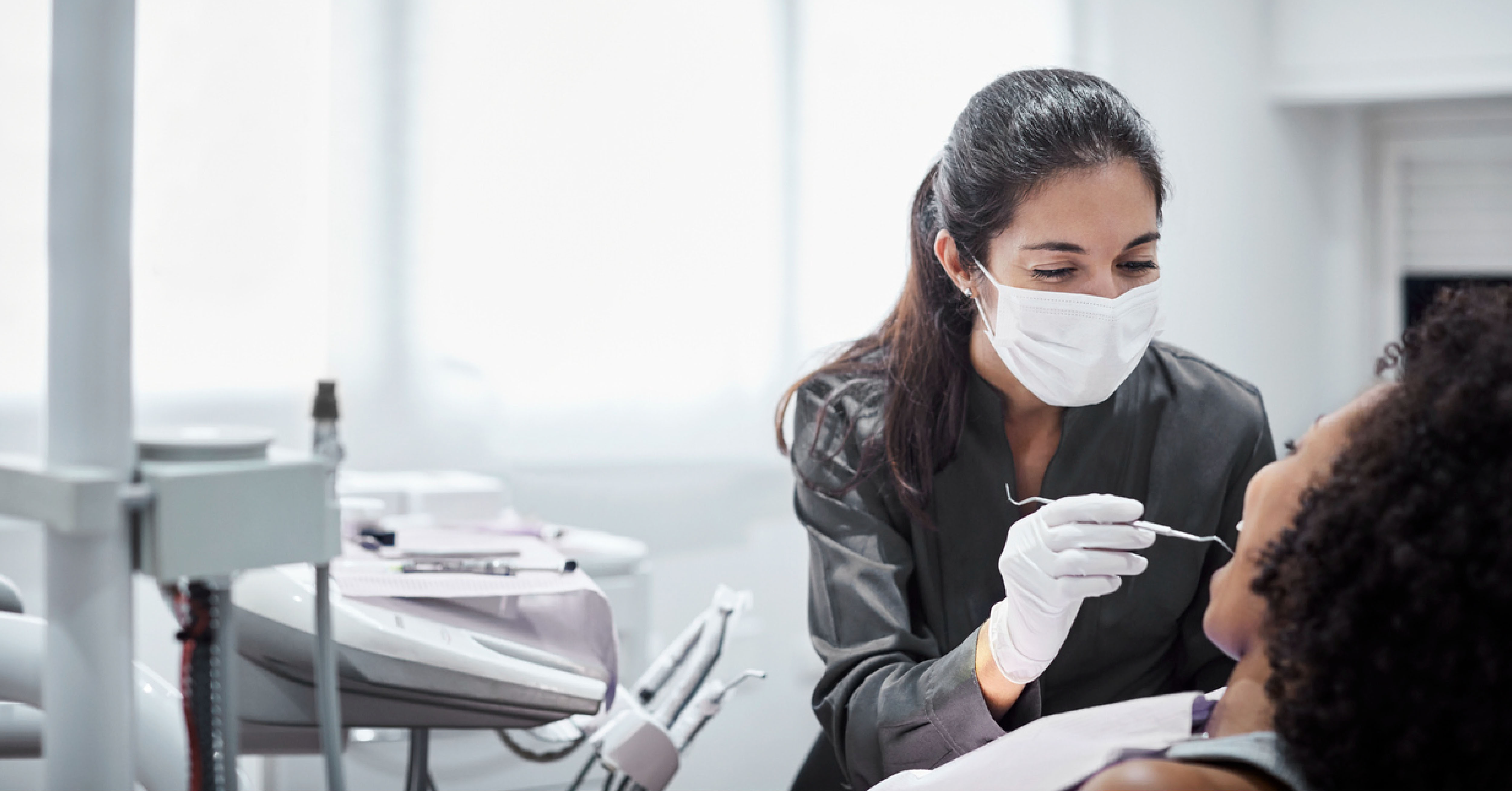 dentist cleaning a patient's teeth